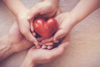 hands-holding-plastic-heart