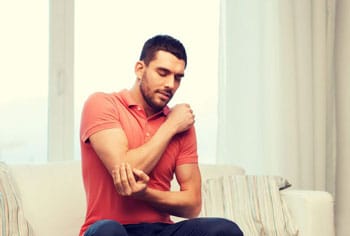 man-with-pain-in-elbow